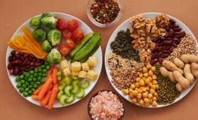 Vibrant display of assorted vegetables, legumes, nuts, and seeds on plates, perfect for healthy eating images.