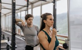 A fit couple engaged in gym exercises. Indoor workout with focus on fitness goals.